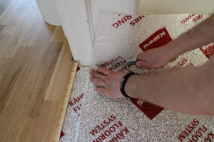 Golvläggare Stockholm proffs på golv.Visar golvfoamsom tillkapas för rätt storlek.